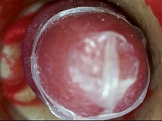 The camera inside the deep pussy records a huge ejaculation with a stuck condom